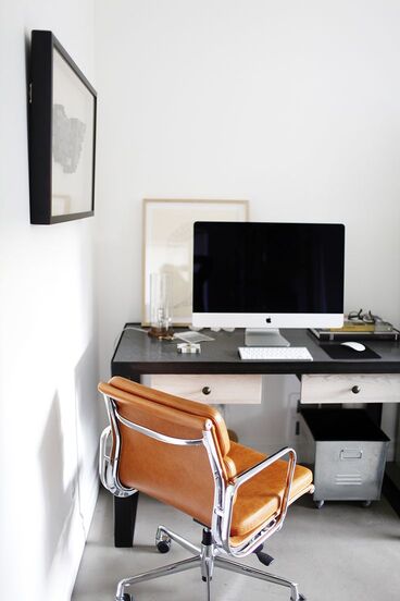 A tidy workspace with a chair and a simple desk